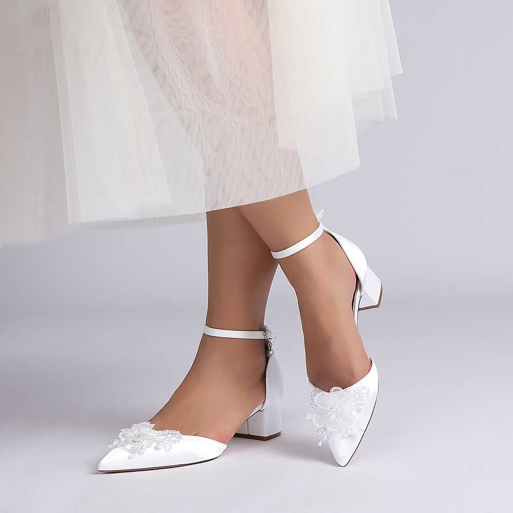 Elegant satin wedding shoes with ankle strap featuring delicate floral embellishments for a bridal look