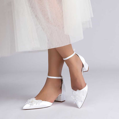 Elegant satin wedding shoes with ankle strap featuring delicate floral embellishments for a bridal look