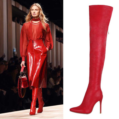 Fashion model wearing sexy thigh high boots with heels on the runway, paired with a red outfit