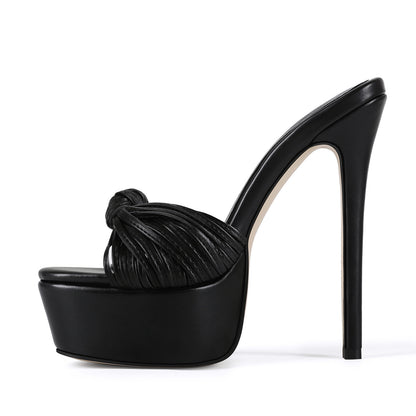 Stylish black leather-look platform stilettos with a statement knot front, shown in side view