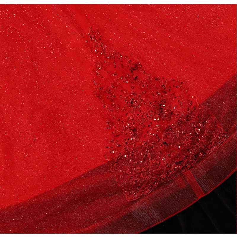 Close-up of a sparkly red ball gown wedding dress featuring intricate sequin detailing on the skirt