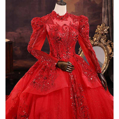 Elegant sparkly red ball gown wedding dress with intricate beading and long sleeves for a stunning bridal look