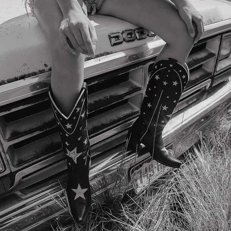 Stylish star embroidered cowboy boots paired with denim shorts, perfect for a chic country look