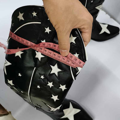 Close-up of star embroidered cowboy boots being measured for size with a tape measure