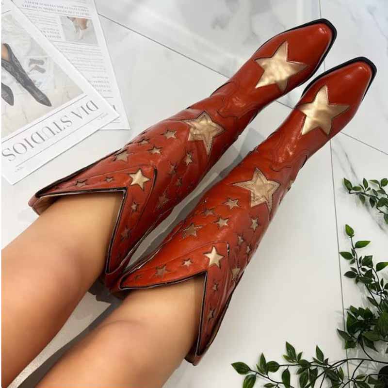 Star embroidered cowboy boots in orange leather with decorative star patterns for a stylish western look