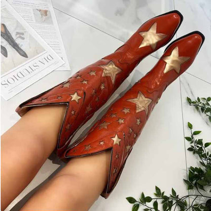 Star embroidered cowboy boots in orange leather with decorative star patterns for a stylish western look