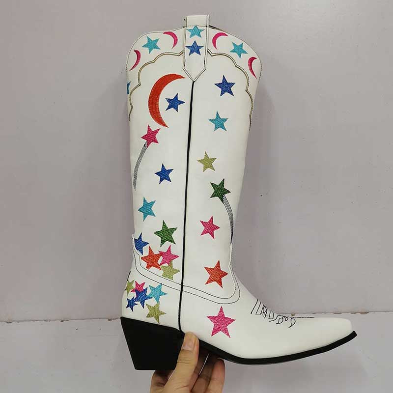 Star pattern knee high cowgirl boots in white with colorful star designs and a stacked heel