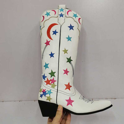 Star pattern knee high cowgirl boots in white with colorful star designs and a stacked heel