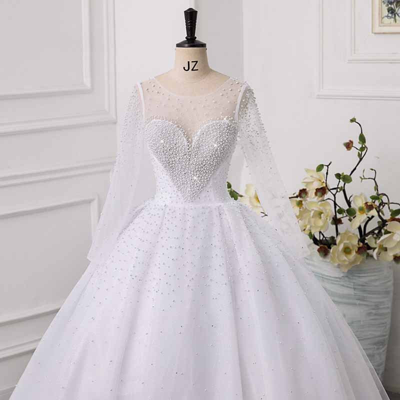Elegant sweetheart tulle wedding dress with long sheer sleeves and pearl embellishments