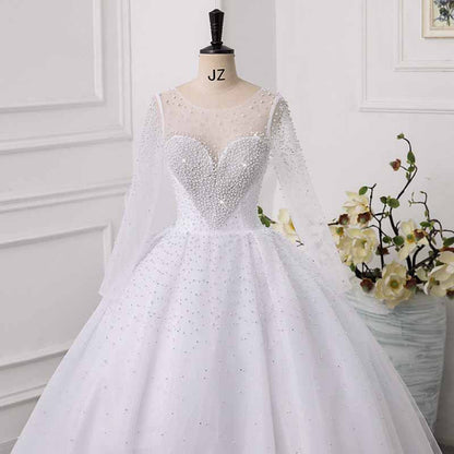 Elegant sweetheart tulle wedding dress with long sheer sleeves and pearl embellishments