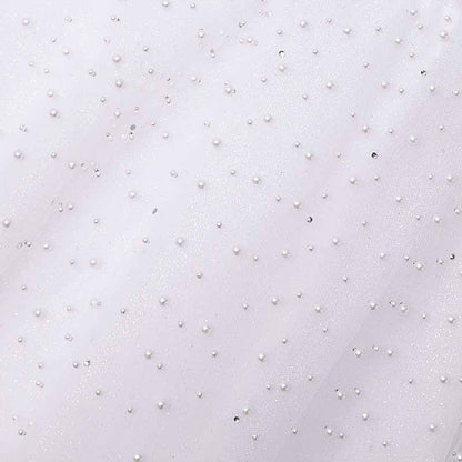 Close-up of a sweetheart tulle wedding dress adorned with delicate pearl embellishments