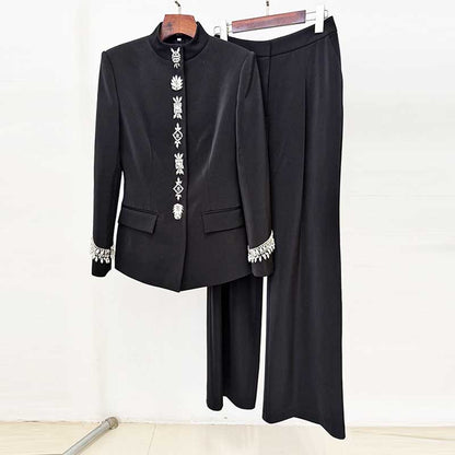 Elegant tailored wide leg trousers suit for women in black with detailed embellishments on the jacket