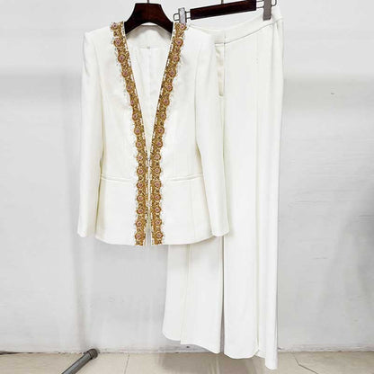 Elegant white tailored women's trouser suit for special occasions with decorative lace detailing