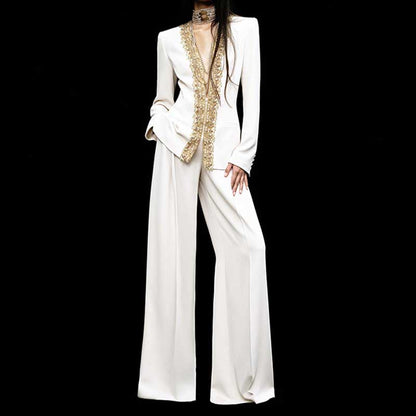 Elegant tailored women's trouser suit for special occasions featuring a embellished blazer and wide-leg pants