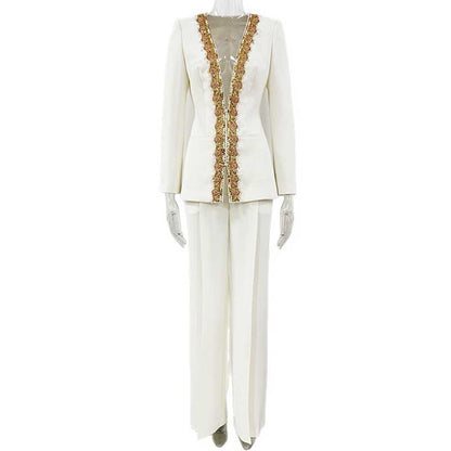 Elegant tailored women's trouser suit for special occasions in white with intricate gold detailing