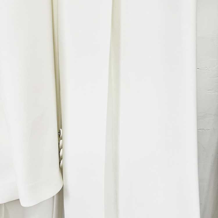 Elegant tailored women's trouser suit for special occasions in a light color with stylish design details