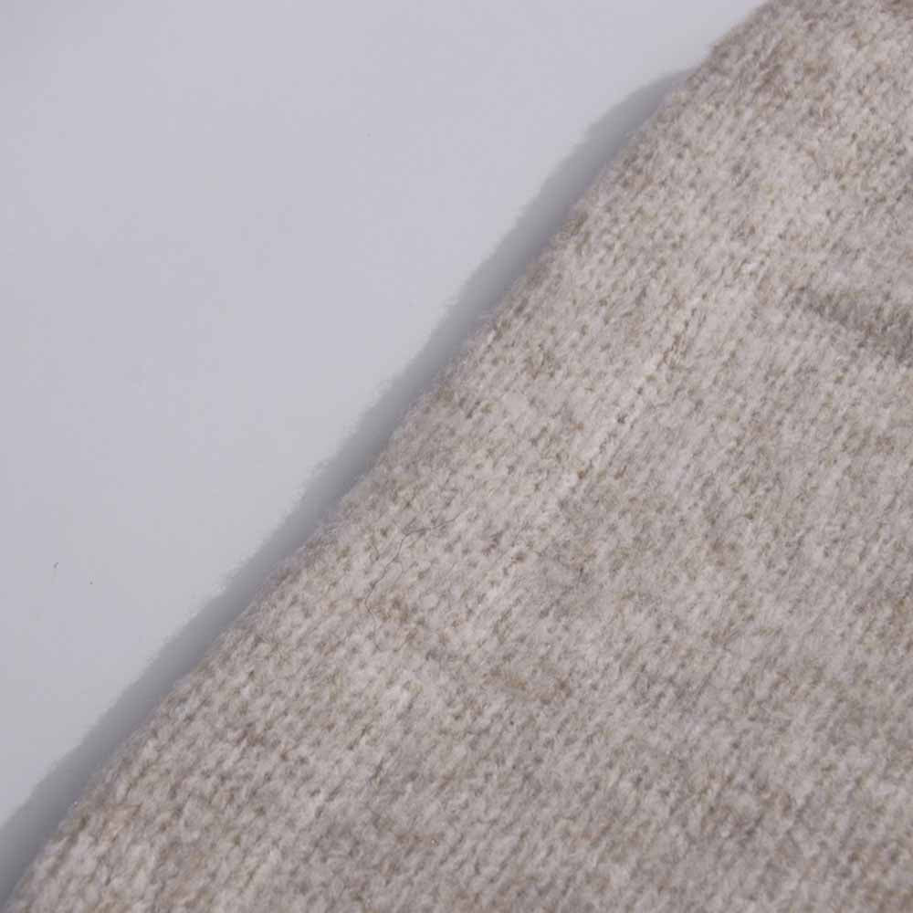 Close-up of a soft fabric from a three piece women's sweater set in beige color
