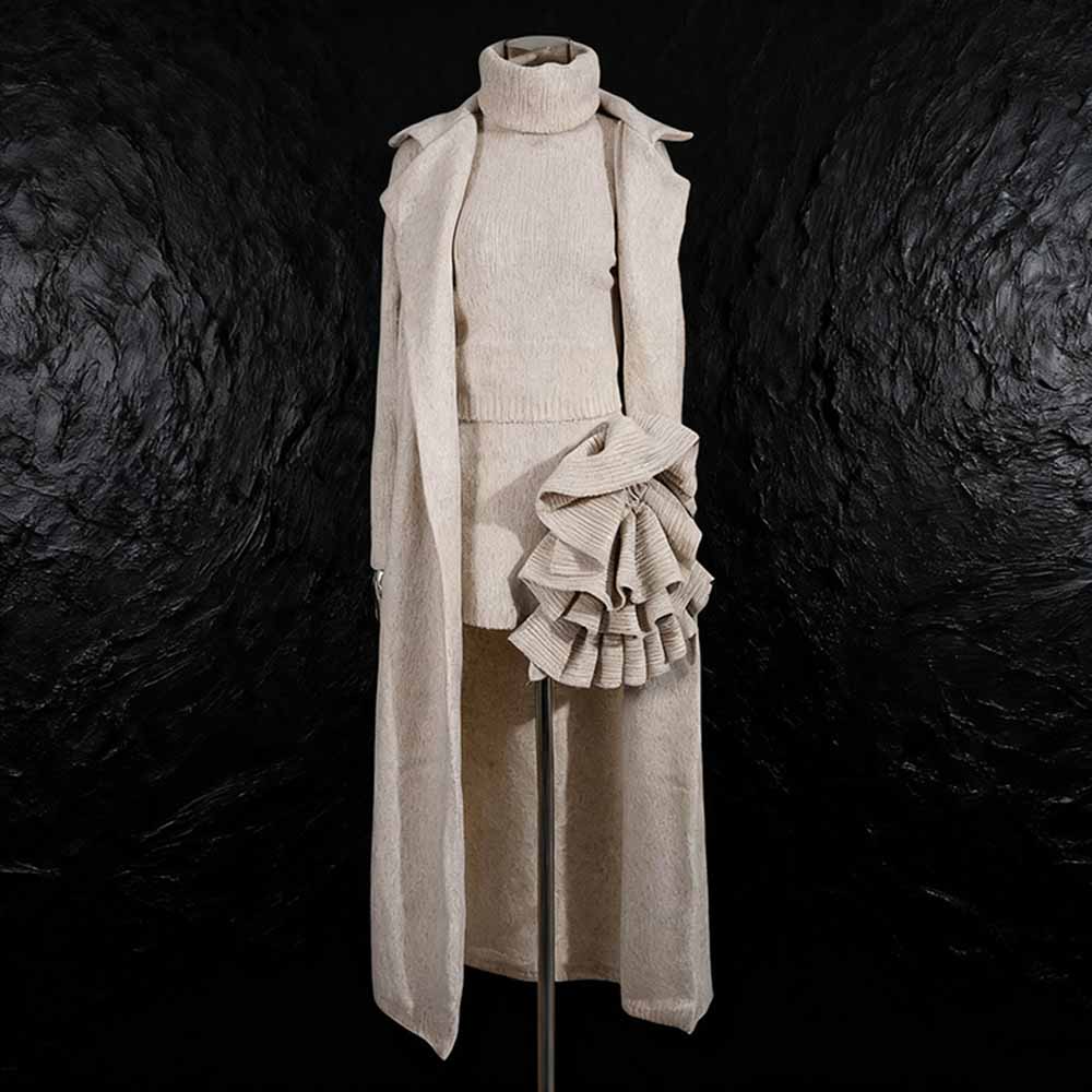 Elegant three piece women's sweater set featuring a turtleneck top, skirt, and long cardigan