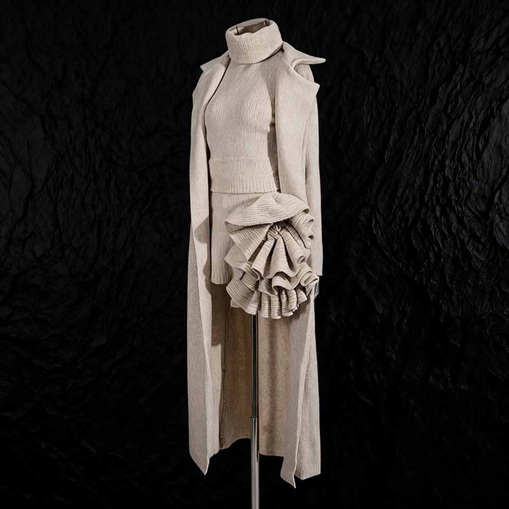 Elegant three piece women's sweater set featuring a stylish long coat and flared skirt for modern fashion