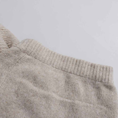 Soft beige fabric detail of a three piece women's sweater set for comfortable layering