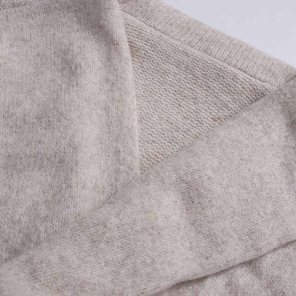 Close-up of a soft beige three piece women's sweater set featuring cozy textured fabric