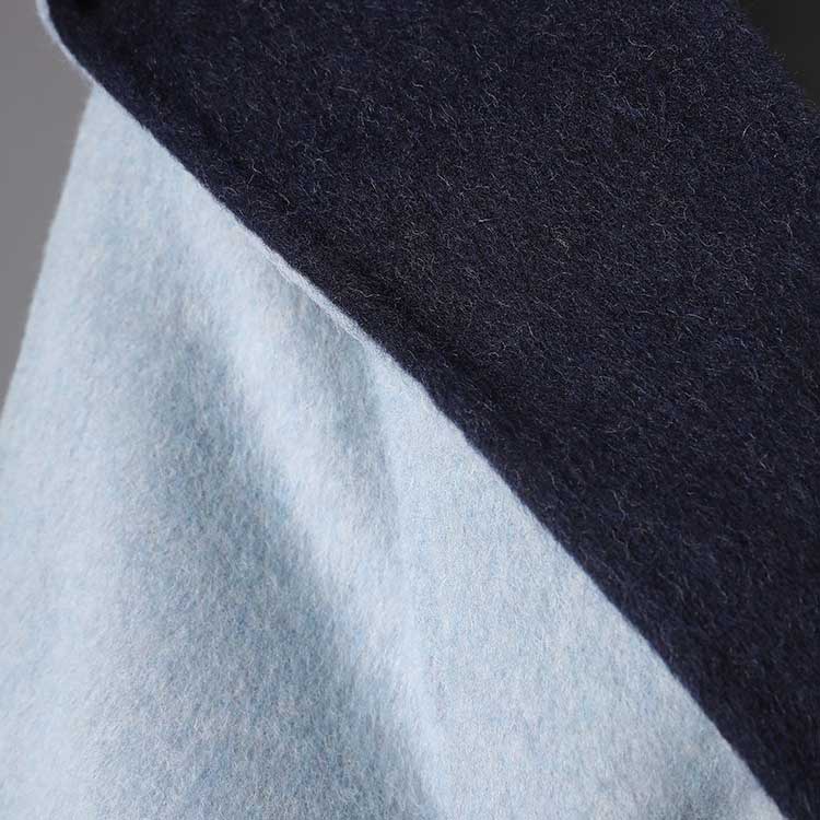 Close-up of the collar of a two-sided winter coat women in soft fabric with contrasting colors