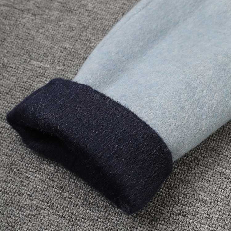 Close-up of cuff detail on two-sided winter coat women, showcasing soft fabrics and contrasting colors