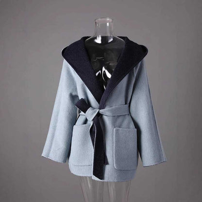 Two-sided winter coat women in light blue and navy with a belt and pockets for added style