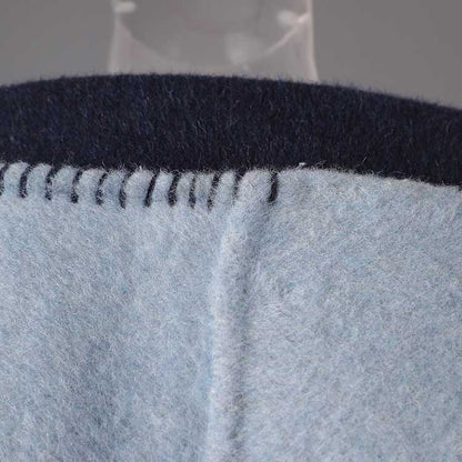 Close-up of a two-sided winter coat women featuring soft fabric and tailored stitching details