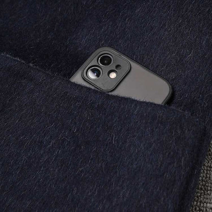 Close-up of a pocket in a two-sided winter coat women with a smartphone inside for convenience