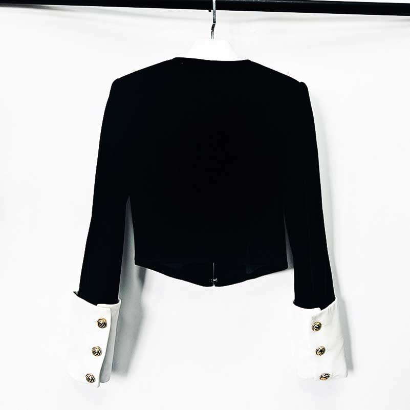 Elegant velvet black blazer with contrasting white cuffs and gold buttons for a chic look
