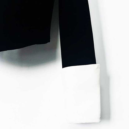Close-up of sd-hk velvet black blazer featuring contrasting white cuffs for a stylish look