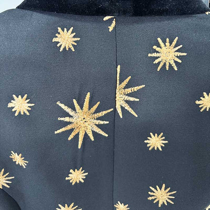 Back view of a stylish velvet feather trim 2-piece suit for women with gold star embellishments