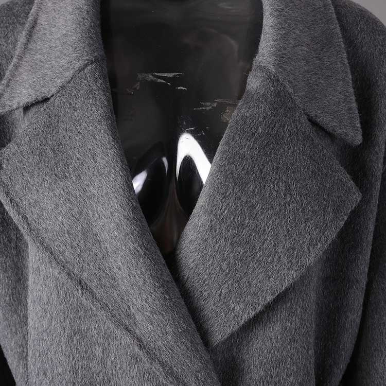 Women's double-breasted grey coat featuring a sleek design and soft fabric for modern style