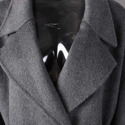 Women's double-breasted grey coat featuring a sleek design and soft fabric for modern style