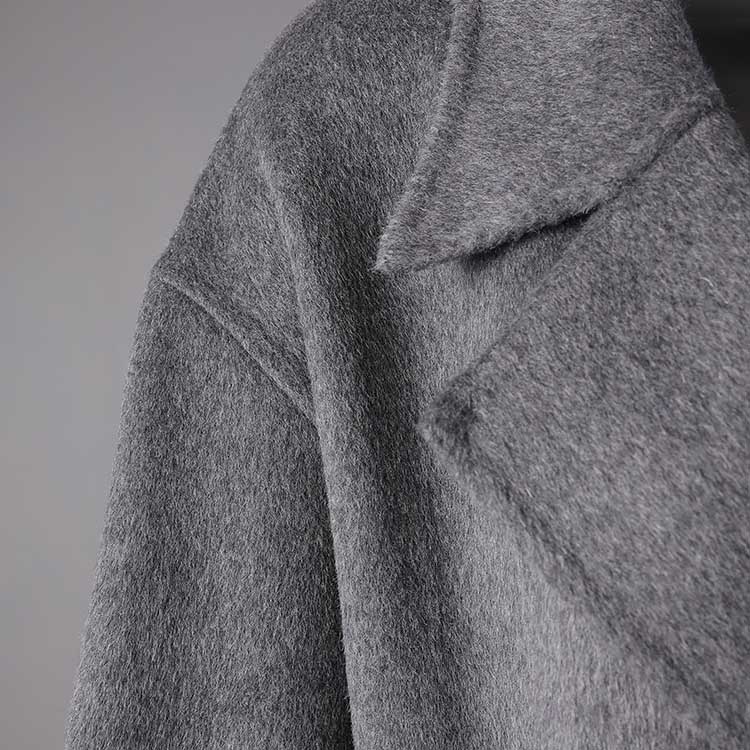 Women's double-breasted grey coat showcasing a chic and stylish design for versatile wear