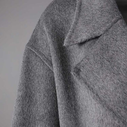 Women's double-breasted grey coat showcasing a chic and stylish design for versatile wear