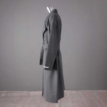 Women's double-breasted grey coat with a stylish belt and elegant design
