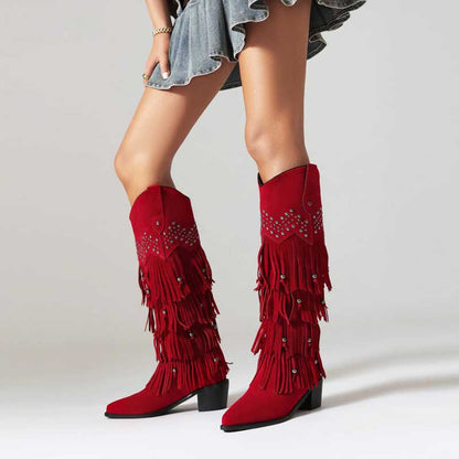 Red vintage tassel cowgirl boots with fringe detailing and decorative studs for a bold western look