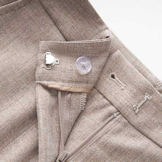 Close-up of a formal women's vest pantsuit wedding featuring elegant fabric and detailed stitching