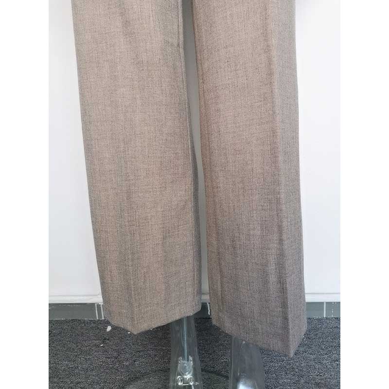 Formal women's vest pantsuit wedding in neutral color with tailored wide-leg trousers.