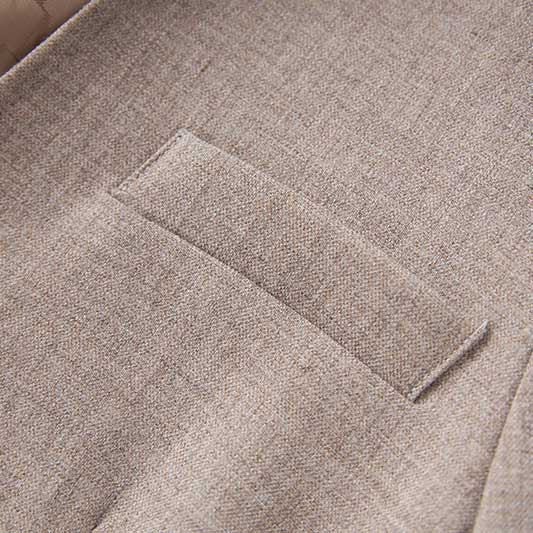 Close-up of SD Dresscode formal women's vest pantsuit wedding showing pocket detail in light beige fabric