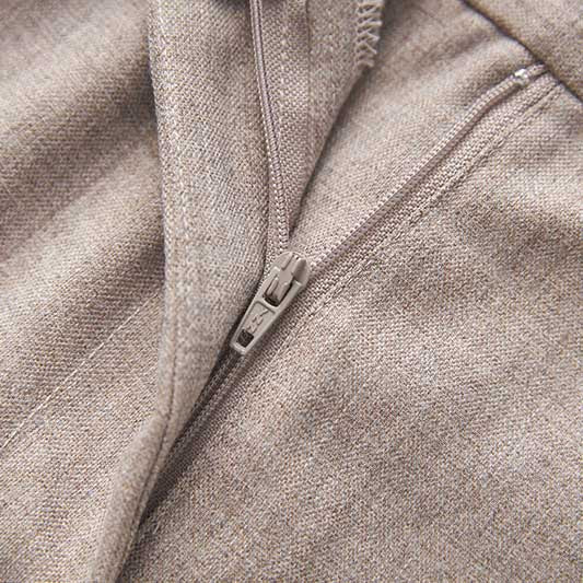 Close-up of a formal women's vest pantsuit wedding with detailed zipper and textured fabric.