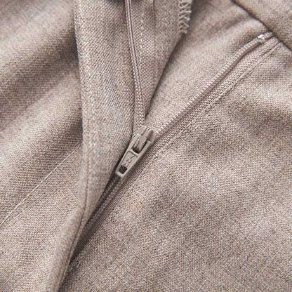 Close-up of a formal women's vest pantsuit wedding with detailed zipper and textured fabric.