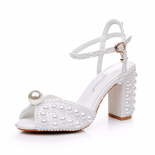 White chunky wedding sandals with pearl embellishments and stylish ankle strap