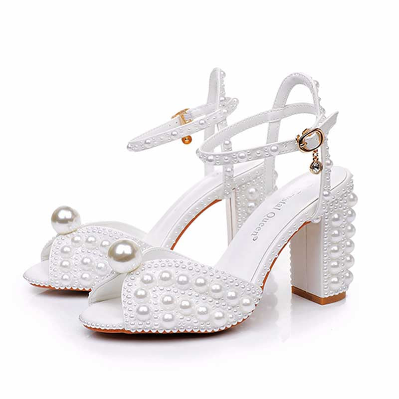 White chunky wedding sandals with pearl embellishments and elegant ankle straps