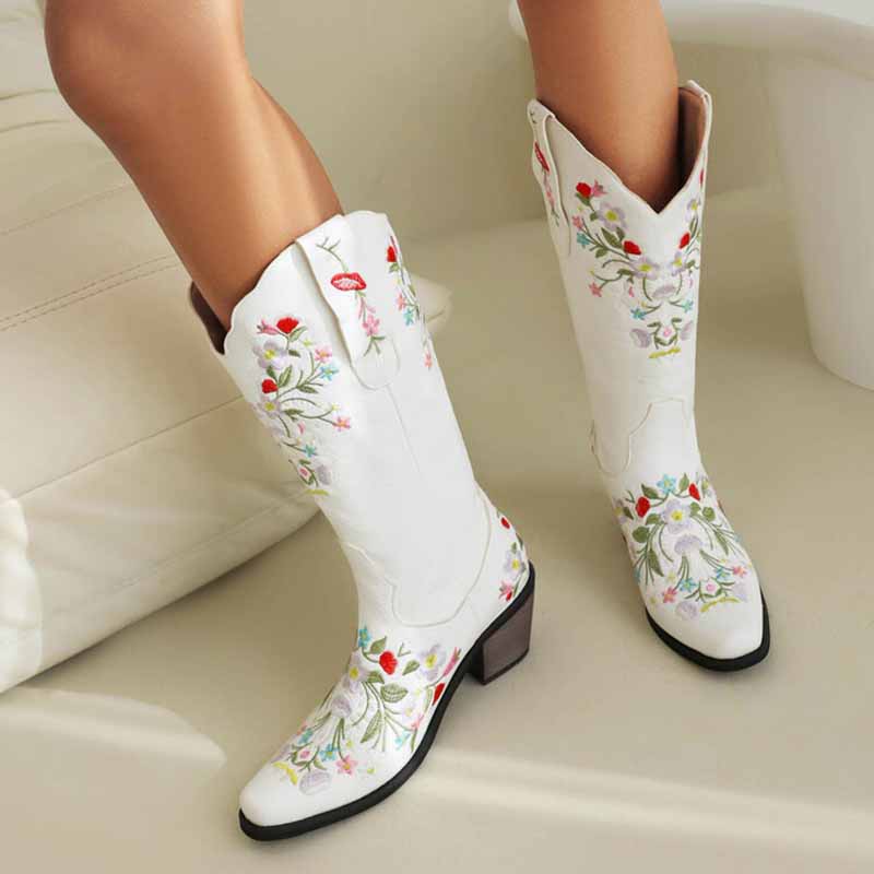Stylish white embroidered cowboy boots for women featuring colorful floral designs and a classic western silhouette