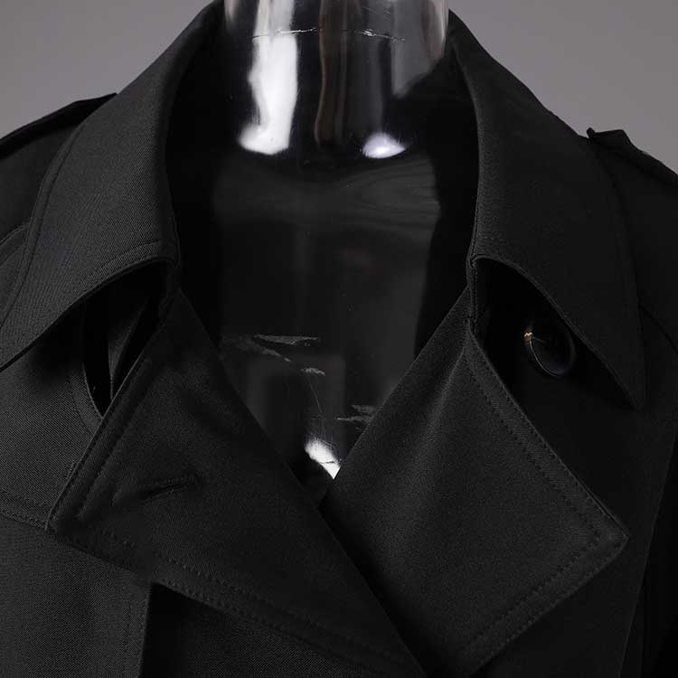 Close-up of a black British style trench coat for women showcasing the collar and fabric details