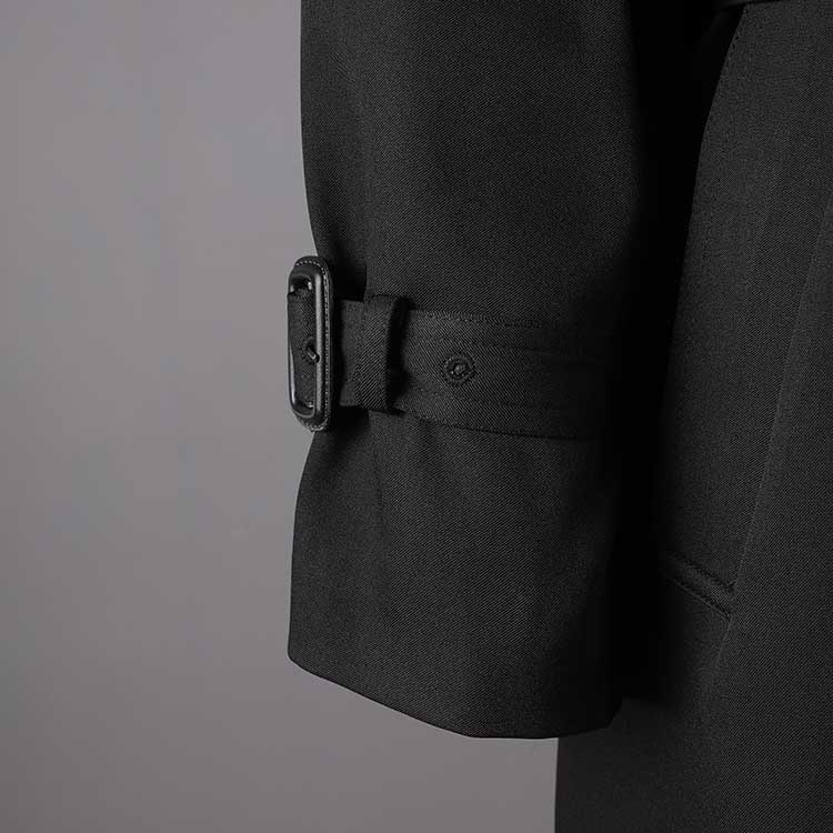Close-up of the cuff detail on a British style trench coat for women, featuring a classic design and buckle