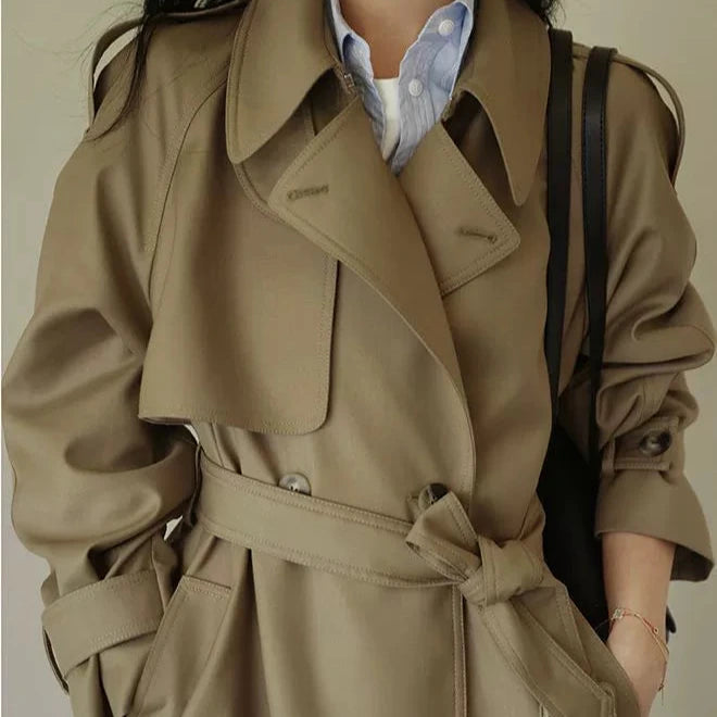 Stylish British style trench coat for women in beige with a belted waist and elegant collar
